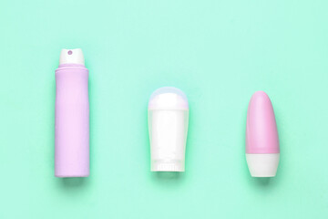 Different deodorant bottles on blue background