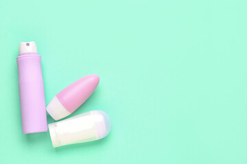 Different deodorant bottles on blue background