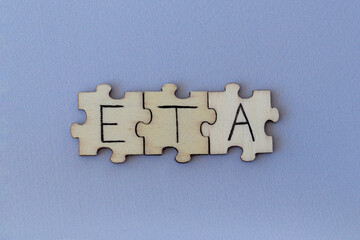 The acronym ETA, which stands for Estimated Time of Arrival. The letters written on the puzzles.