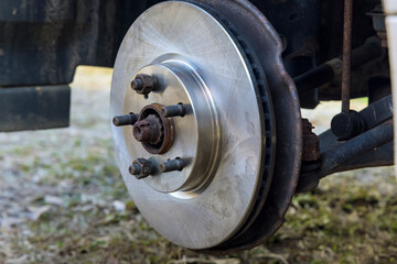 Mechanics in mechanical repair service center replace wheel hub brake disc assemblies with new ones