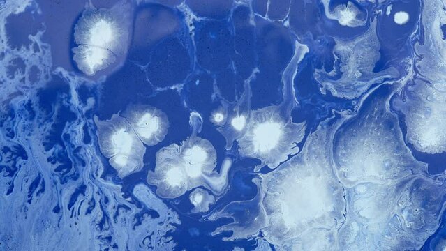Blue pattern of macro paint spreading in liquid. Abstract background. 
