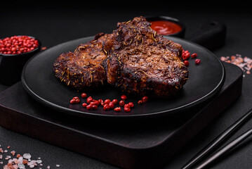 Delicious beef or pork steak on the bone grilled with spices and rosemary