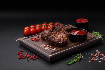 Delicious beef or pork steak on the bone grilled with spices and rosemary