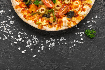 Vegetable pizza with ingredients on dark background