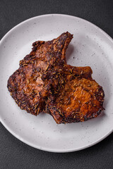 Delicious beef or pork steak on the bone grilled with spices and rosemary