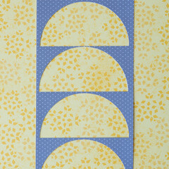 paper stencil with half circle cutouts on floral scrapbook paper