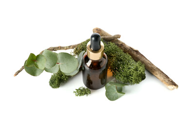 Bottle of cosmetic oil with moss, eucalyptus and branch on white background