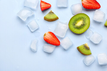Sliced fresh strawberry with kiwi and ice cubes on blue background