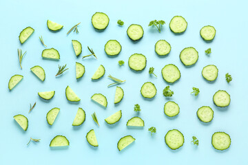 Slices of cucumber with rosemary and parsley on turquoise background