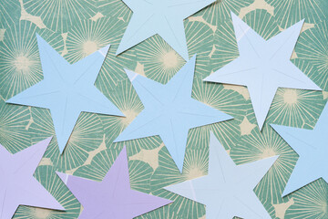 mostly blue and violet cut paper stars on scrapbook paper with florals