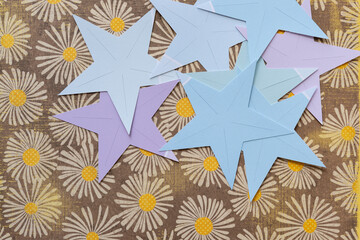 cut paper stars on decorative floral scrapbook paper