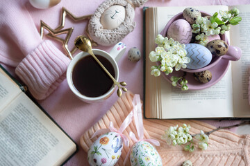 A cup of hot coffee on a festive Easter table with colored eggs.