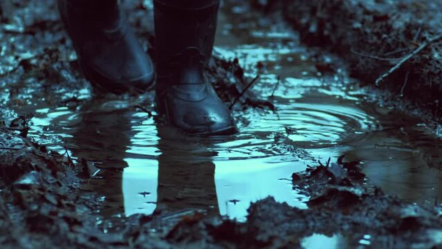 Walking through a muddy puddle in rubber boots on a forest road in the evening. High quality binaural audio recording. ASMR style video and sound.