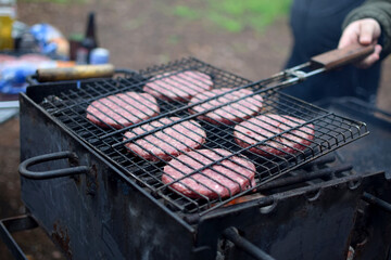 grilled chicken and vegetables on the grill. hamburger cutlets on the grill. Cooking outdoors