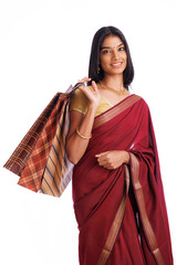 Beautiful Indian traditional woman holding shopping bags and smiling