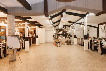 The large hall of the cafe is decorated for the autumn wedding