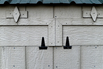 Amish chicken coop nesting box doors. Rustic, symmetric.