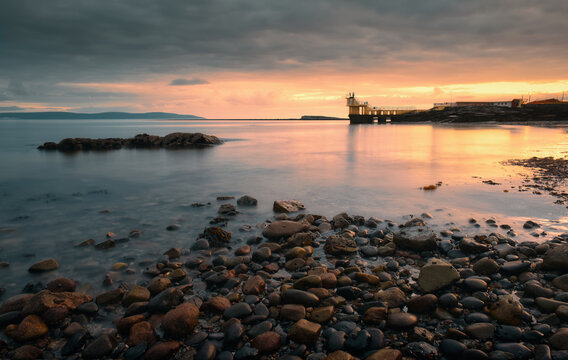 Dramatic coastal sunset landscape scenery with blackrock diving tower on Salthill beach, Galway, Ireland 