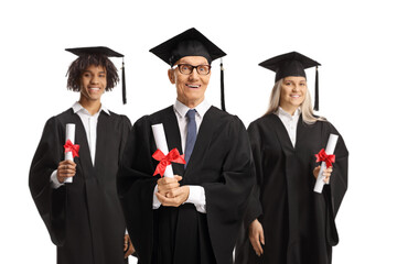 Elderly man and graduate students in gowns holding diplomas