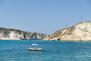 Fototapeta na wymiar a dinghy moored in the gulf between the tremiti islands