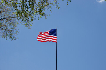 American flag waving in the breeze on a sunny day