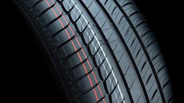 CLOSE UP OF TIRE TREAD FOR CAR GRIP FOR SAFETY. COPY SPACE FOR WORKSHOPS ADVERTISEMENT BROCHURES.
