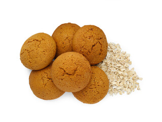 Delicious oatmeal cookies and flakes on white background, top view