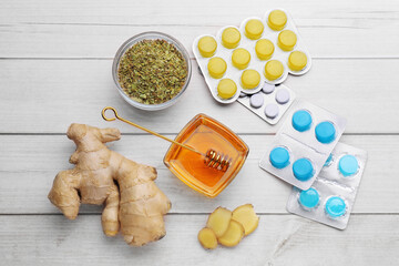 Cold remedies and pills on white wooden table, flat lay. Cough treatment