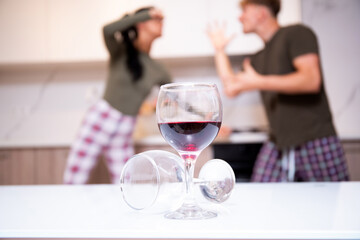 An alcoholic husband quarrels with his wife at home, sitting on the couch