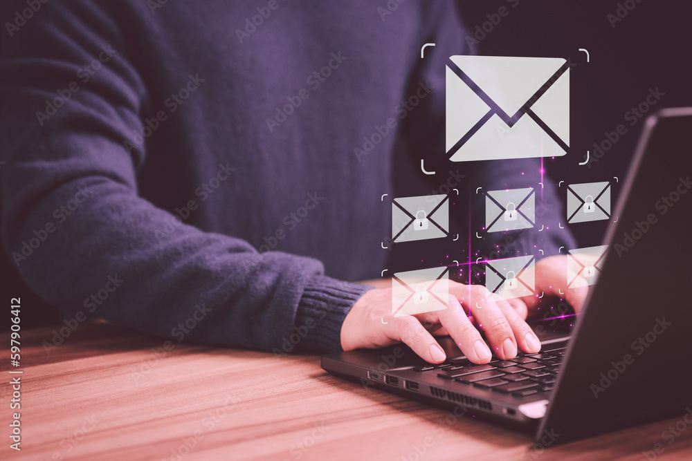 Aufkleber Man hand using computer laptop typing on keyboard and surfing the internet on office table with email icon. Concept of Email marketing, send e-mail or news letter, online working internet network.