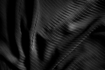 Dark black and gray blurred gradient and line of cloth or fablic background has a little abstract light.