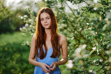 Elegant beautiful young woman portrait smile with teeth in the park in nature in the sunset light of summer