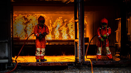 Firefighter Concept. Fireman using water and extinguisher to fighting with fire flame. firefighters...