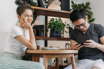 Bad asian couple date of man addicted to mobile game and woman gets mad.