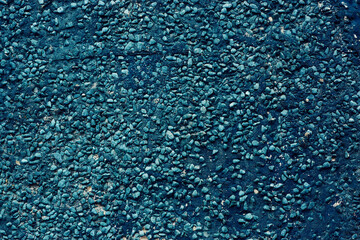 a wall of small stones of dark blue color