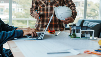 Civil engineer teams meeting house rebuilding foundation construction planning and blueprints at...