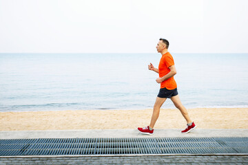 Active senior man in sport clothes is jogging. Healthy lifestyle.