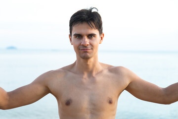 Abstract blur sparklers for celebration. Caucasian man hand holding burning Christmas sparkle on beach