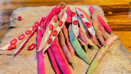 red beans in a basket on a wooden background. closeup of red kidney beans in pod