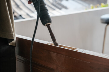 Carpenter man working on wooden door in new house building