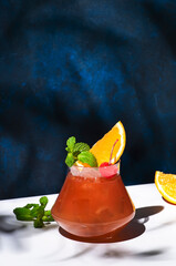 Painkiller alcoholic cocktail drink with dark rum, pineapple juice, coconut ssrop, orange, mint,...