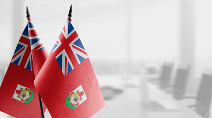 Small flags of the Bermuda on an abstract blurry background