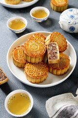 Obraz na płótnie Canvas Traditional Chinese dessert. Homemade baked mooncakes filled with nuts and dried fruits, Chinese Mid-Autumn Festival food.
