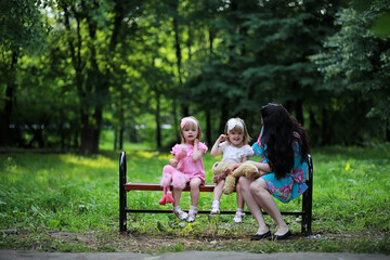 Fototapeta na wymiar Mom with two daughters twins