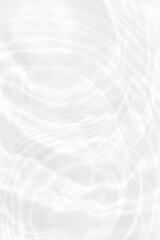 White water with ripples on the surface. Defocus blurred transparent white colored clear calm water surface texture with splashes and bubbles. Water waves with shining pattern texture background.