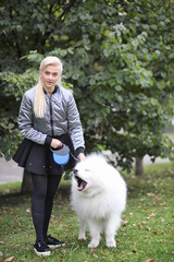 Lovely girl on a walk with a beautiful dog