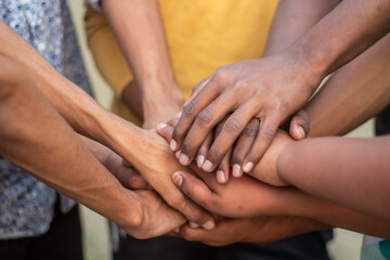 One hand down and the other hands on top of that hand © Rokonuzzamnan