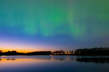 northern lights and its reflection the lake, northern lights shimmer over the lake, northern lights...