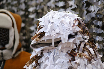 Military uniform on a mannequin as a sample for sale in a store. An army headdress worn on a soldier's dummy