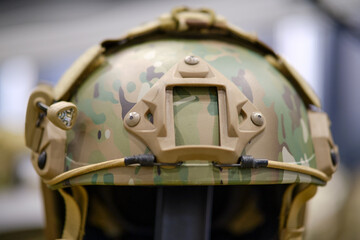 The army clothing store showcases the khaki helmet that forms part of the soldier's military uniform.
